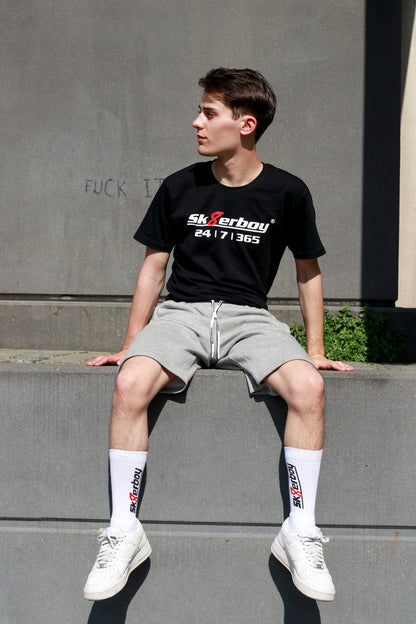 hübscher twink im freien mit fetisch klamotten von sk8erboy trägt die weißen sk8erboy crew socks bei schönem wetter