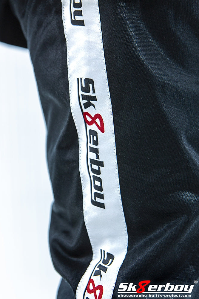 nahaufnahme der seite mit weissem banner und logo von sk8erboy auf der shiny pants glanzhose fuer zu hause als home-tracksuits