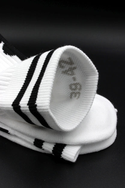 weisse sk8erboy berlin socken mit brandenburger tor und funkturm am bund auf der unterseite mit großem logo und BERLIN schriftzug  in detailansicht mit grösse im bund